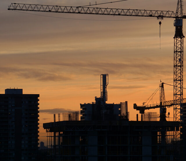 Closeup shot of an ongoing construction  with tracks and a bulldozer on an  abandoned land
