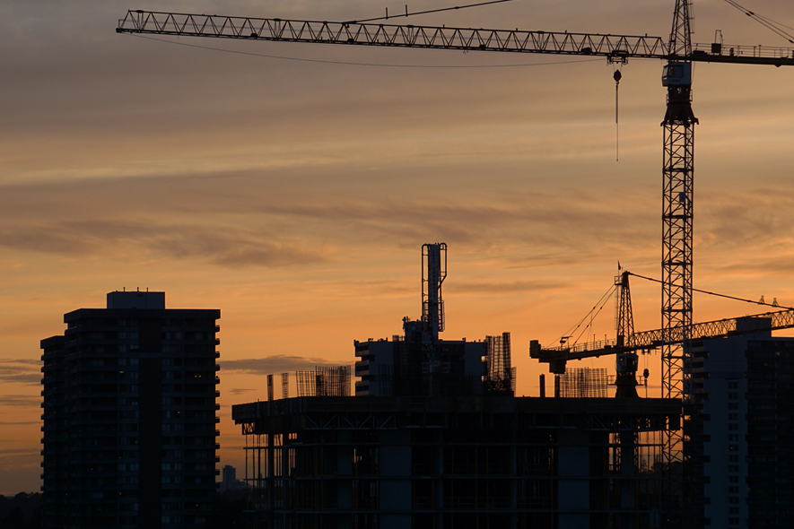 Closeup shot of an ongoing construction  with tracks and a bulldozer on an  abandoned land